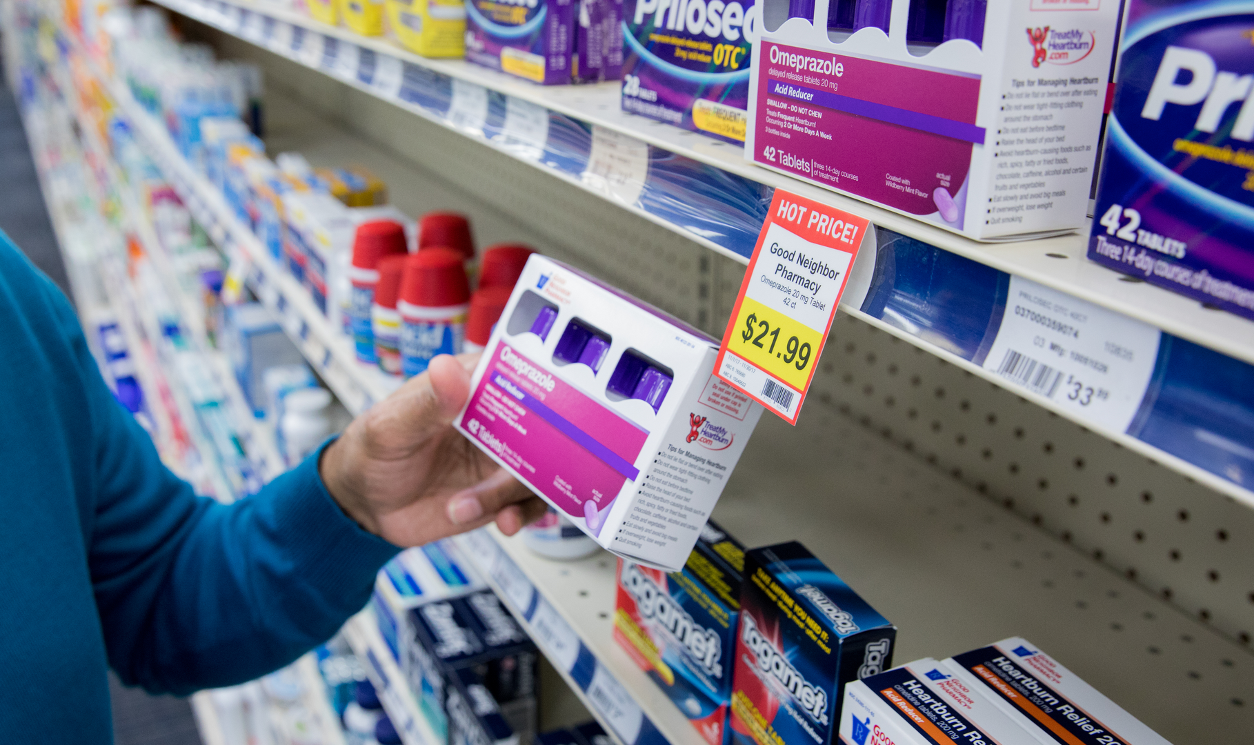 A man shopping for over-the-counter medication in an independent pharmacy