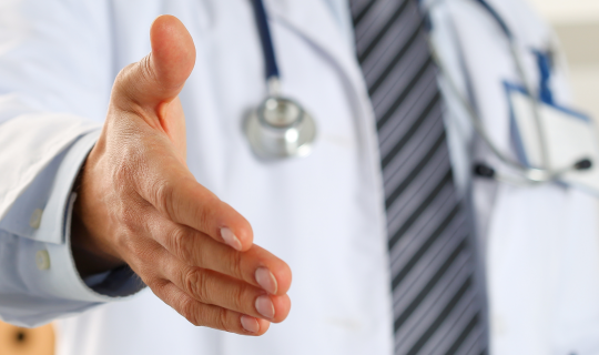 A doctor extending his hand to shake hands