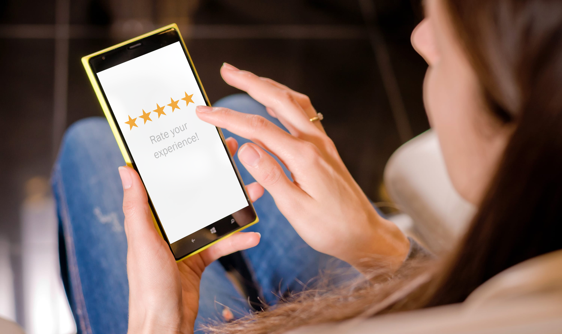 A woman giving a business a star rating on her phone