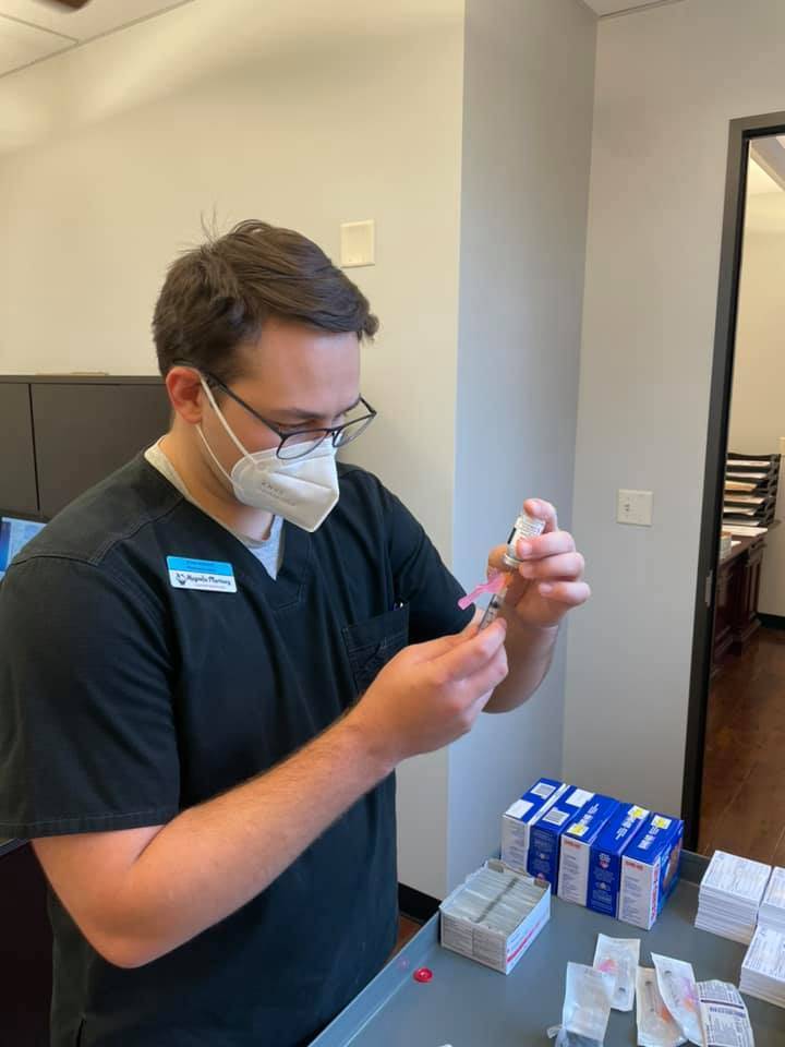 An independent pharmacist preparing to administer COVID-19 vaccinations